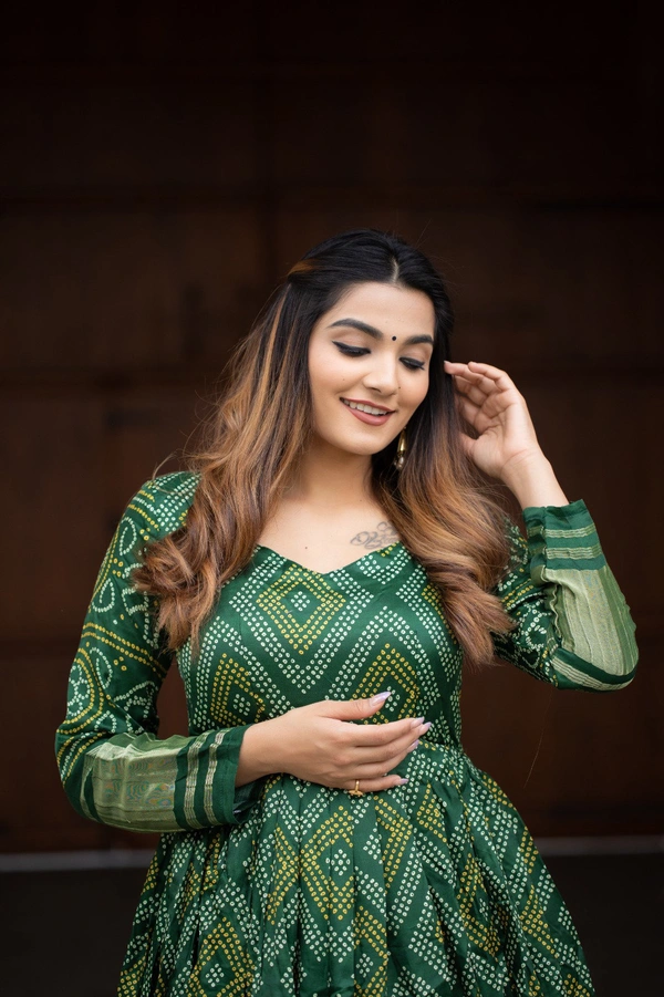 Antique Fashion  Presenting a perfectly blended endless array of patterns, designs and  colors , that represents a vibrant indian culture & true essence of our traditional gaji silk bandhej gown. - green