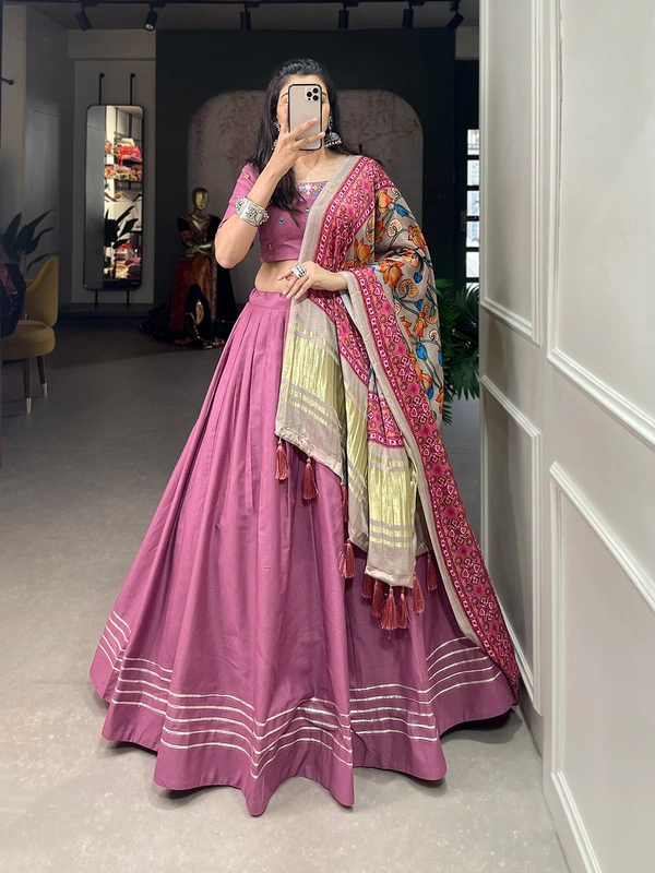 Antique Fashion  Get traditional look of your choice with this classic yet conventional plain lehenga and mirror work blouse 