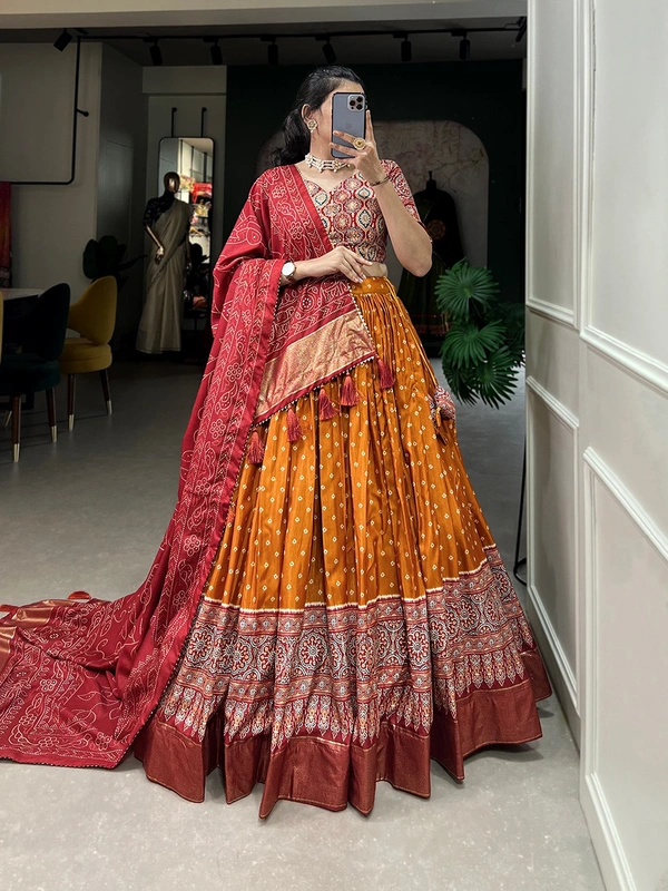 Antique Fashion 1 The timeless bandhani print chaniya choli showcases intricate ajrakh print and foil lacework  combining elegance and tradition in a stunning ensemble for Function  - Orange