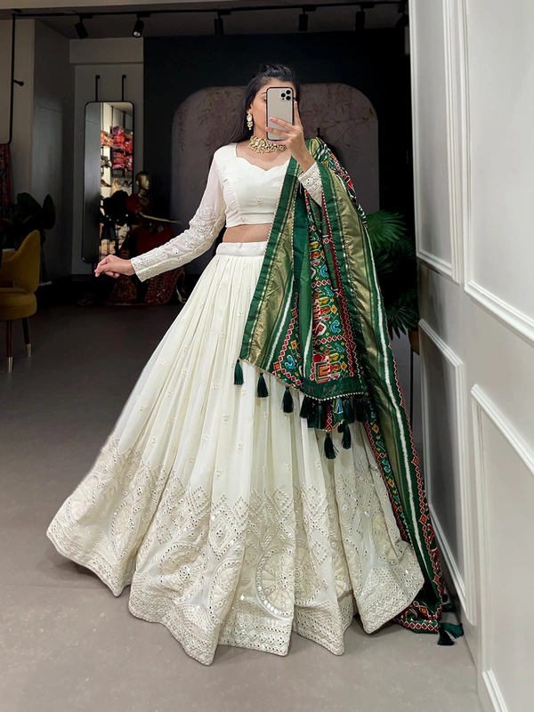 Antique Fashion  Experience timeless elegance with this beautiful lucknowi paper mirror work lehenga  - white + green