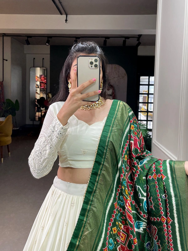 Antique Fashion  Experience timeless elegance with this beautiful lucknowi paper mirror work lehenga  - white + green