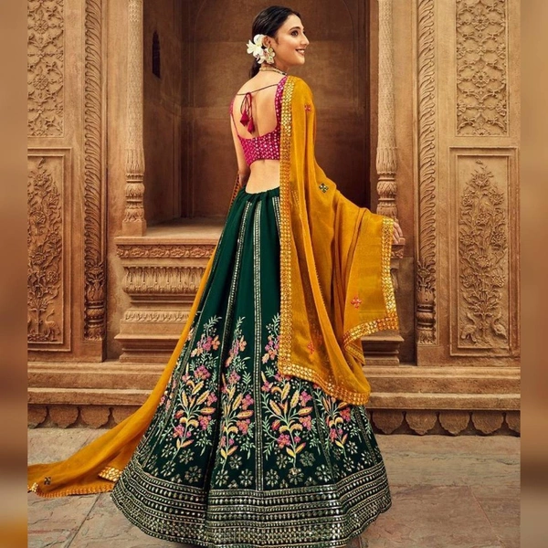 DC-2040 Green Colour Embroidered Attractive Party Wear Silk Lehenga choli has a Regular-fit and is Made From High-Grade Fabrics And Yarn. - FREE