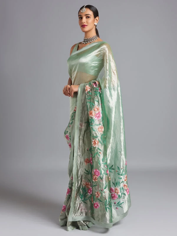 Green ombré on a silver silk tissue saree with hand-painted and embroidered details.