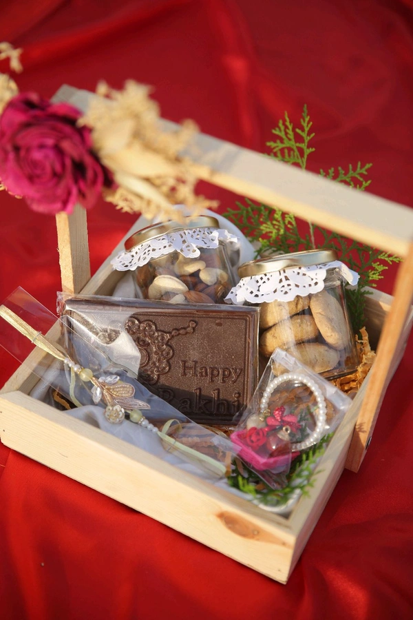Rakhi Hamper Contains 1 Jar Of Chocolate,1 Jar Of Cookies,1 Rakhi Bar Chocolate and a Rakhi