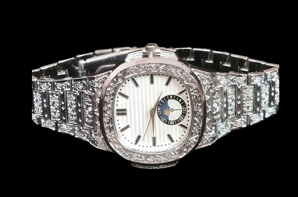  Regal Nocturne Timepiece
Elevate your style with the Regal Nocturne Timepiece – a masterfully engraved luxury watch that blends timeless elegance with bold craftsmanship. Featuring a textured dial, moonphase subdial, and intricate metalwork, this statement piece is designed for those who appreciate sophistication in every second. - Silver