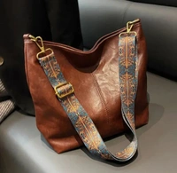 Black Leather-Look Sling Bag with Broad Patterned Strap and Coin Purse