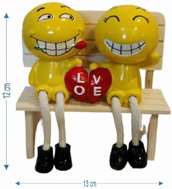 Couple polyresin statues on wooden bench