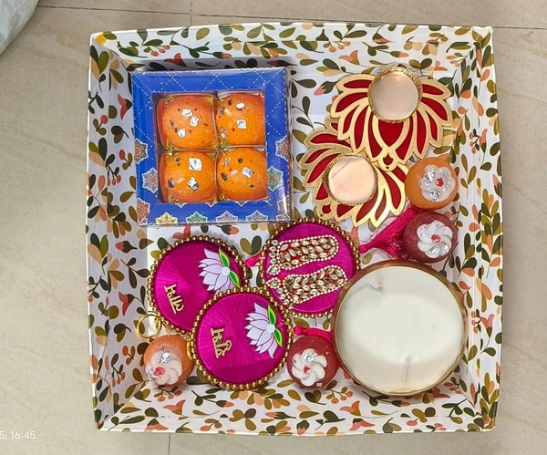 New diwali combo in tray 1 box laddu candles 1 box mithai candles 1 pair shubh labh 1 lakshmi charan 2 pc lotus tealight holder 1 katori urli with wax Color random throughout