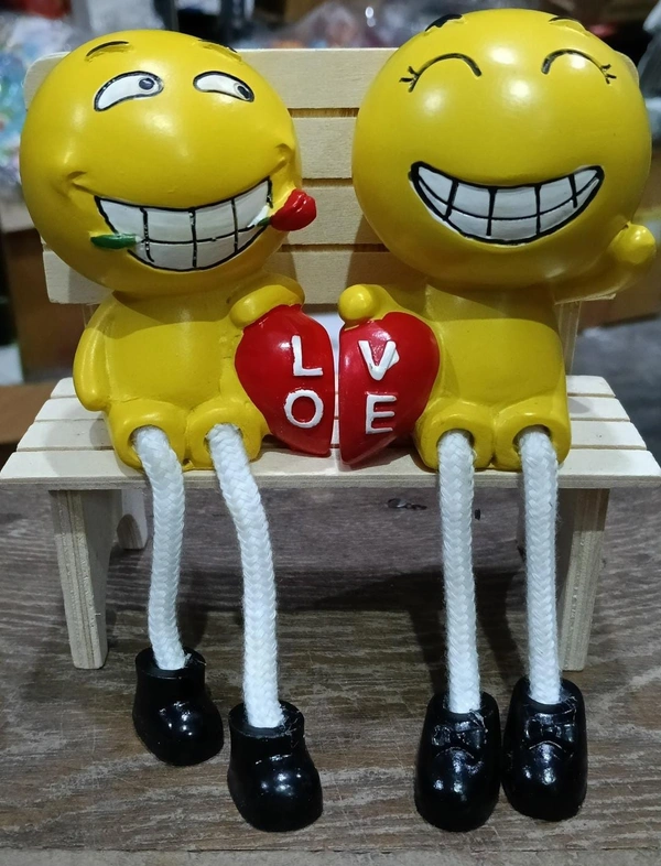 Couple polyresin statues on wooden bench
